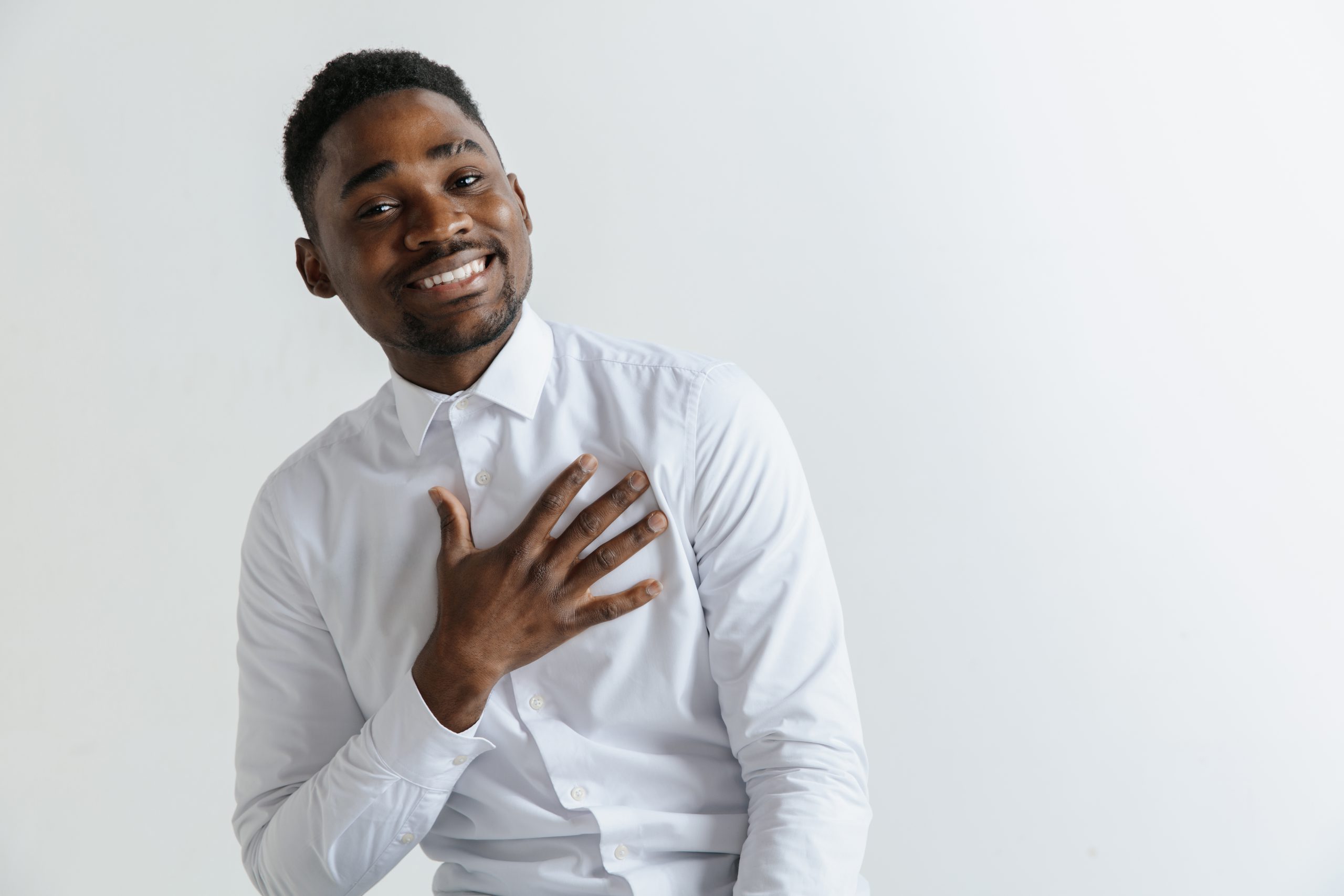 Man holding hand over heart expressing gratitude